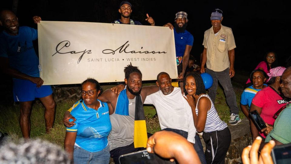 Community supporters with a banner at night
