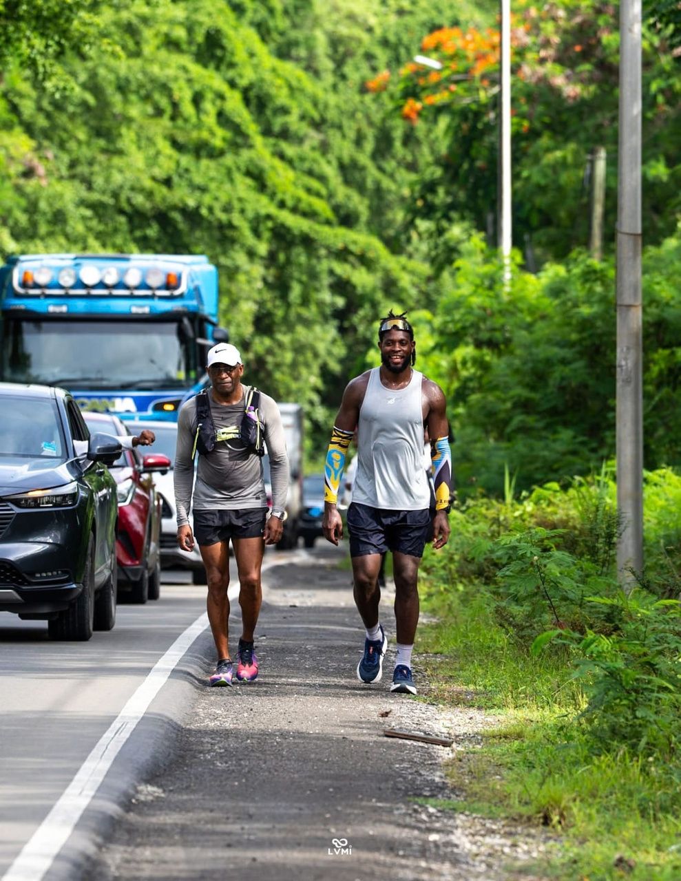 Jordan running with supporters on a Saint Lucian road